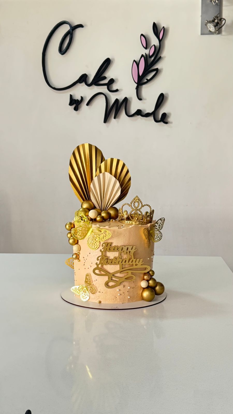 Pastel de lujo para cumpleaños o eventos especiales con decoración de gala, topper de "Happy Birthday" dorado y acabados artísticos refinados.